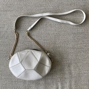 White geometric crossbody bag with gold hardware